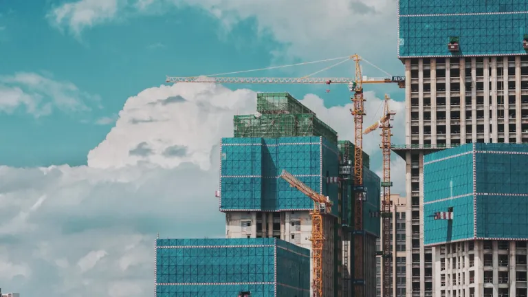 High-rise towers under construction with cranes