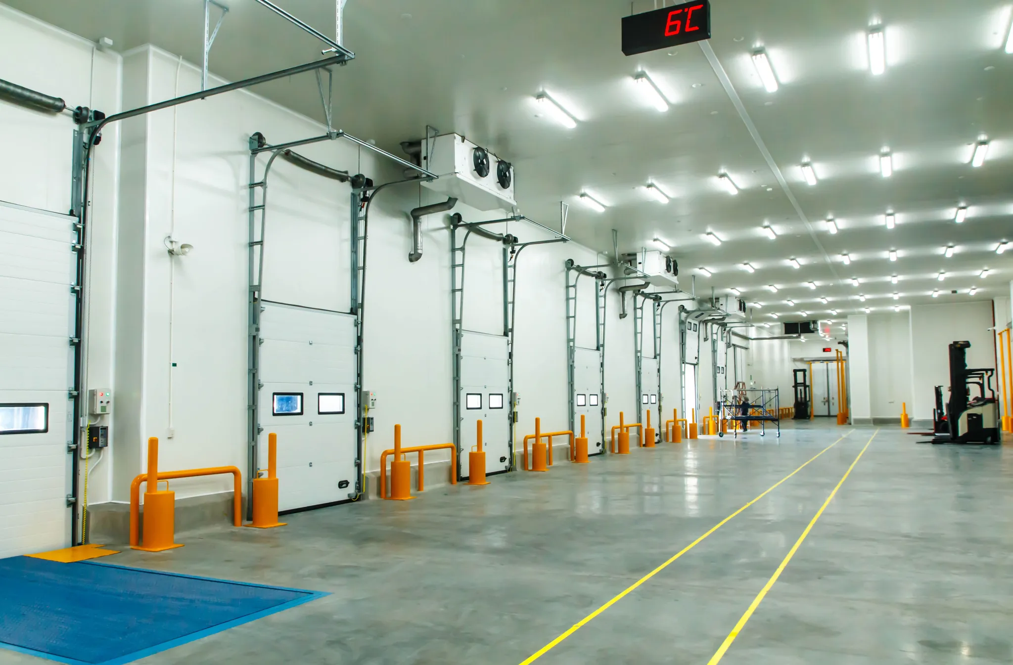 Cold storage loading dock with insulated roller doors and safety bollards