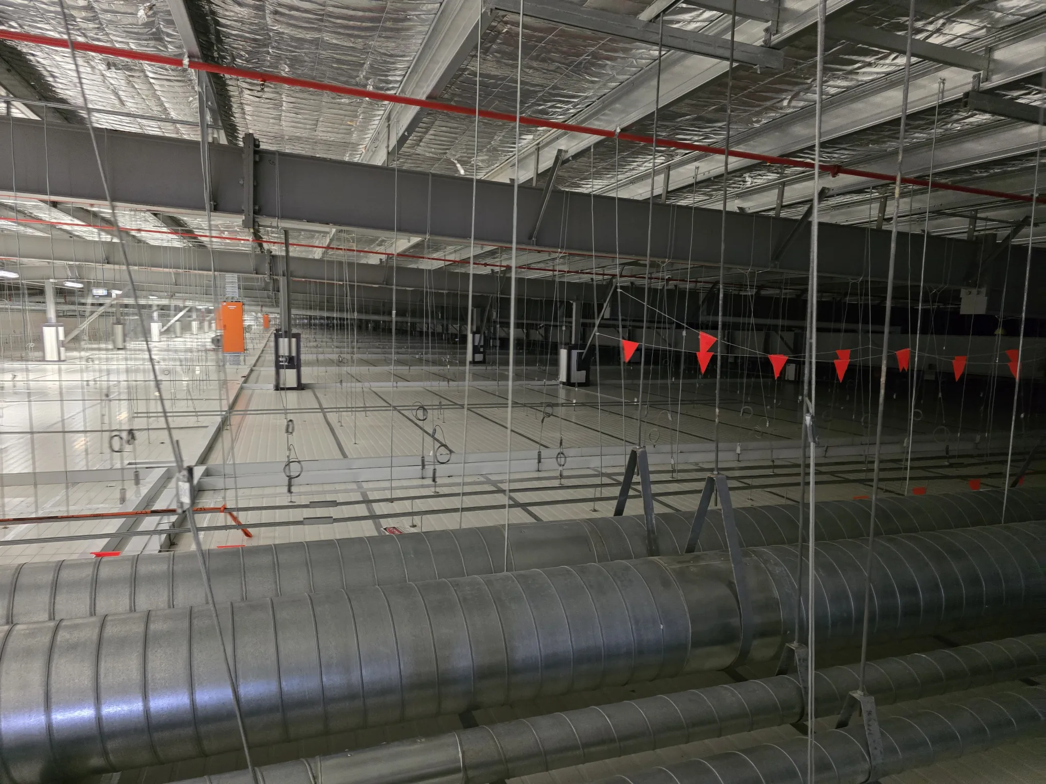Spiral ductwork running through a large commercial building under construction