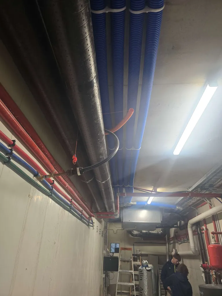 HiDEW climate control unit mounted in a plant room with insulated ducts and pipework
