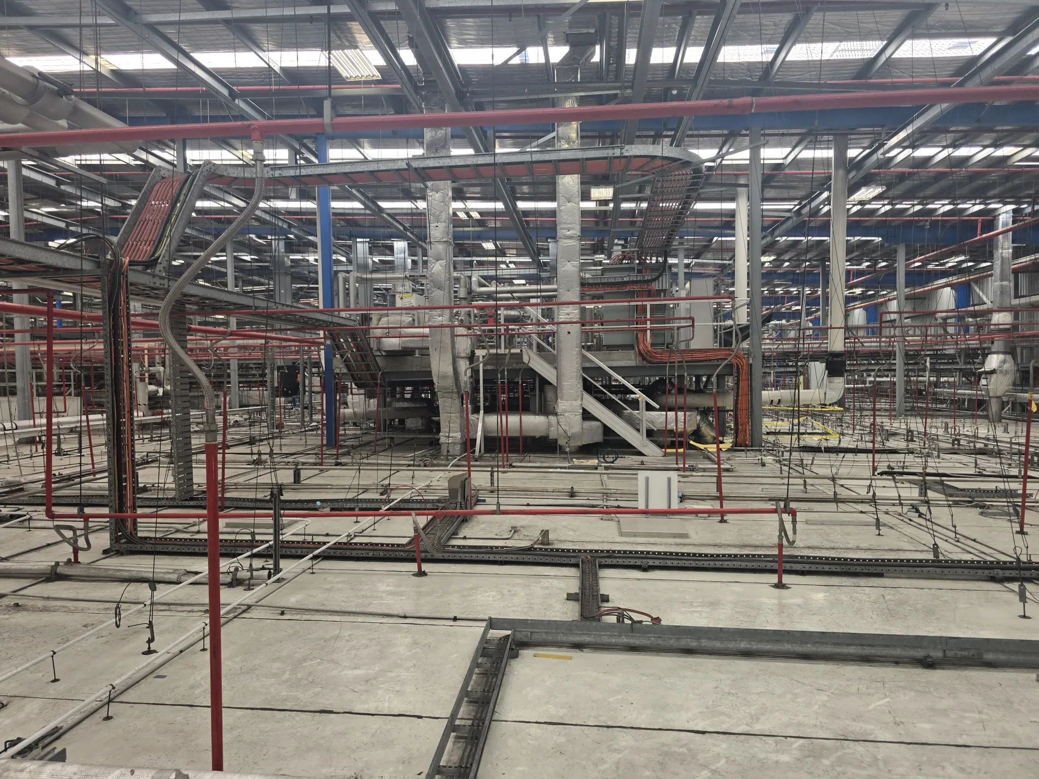 Interior of an industrial plant with pipe racks and mezzanine steelwork