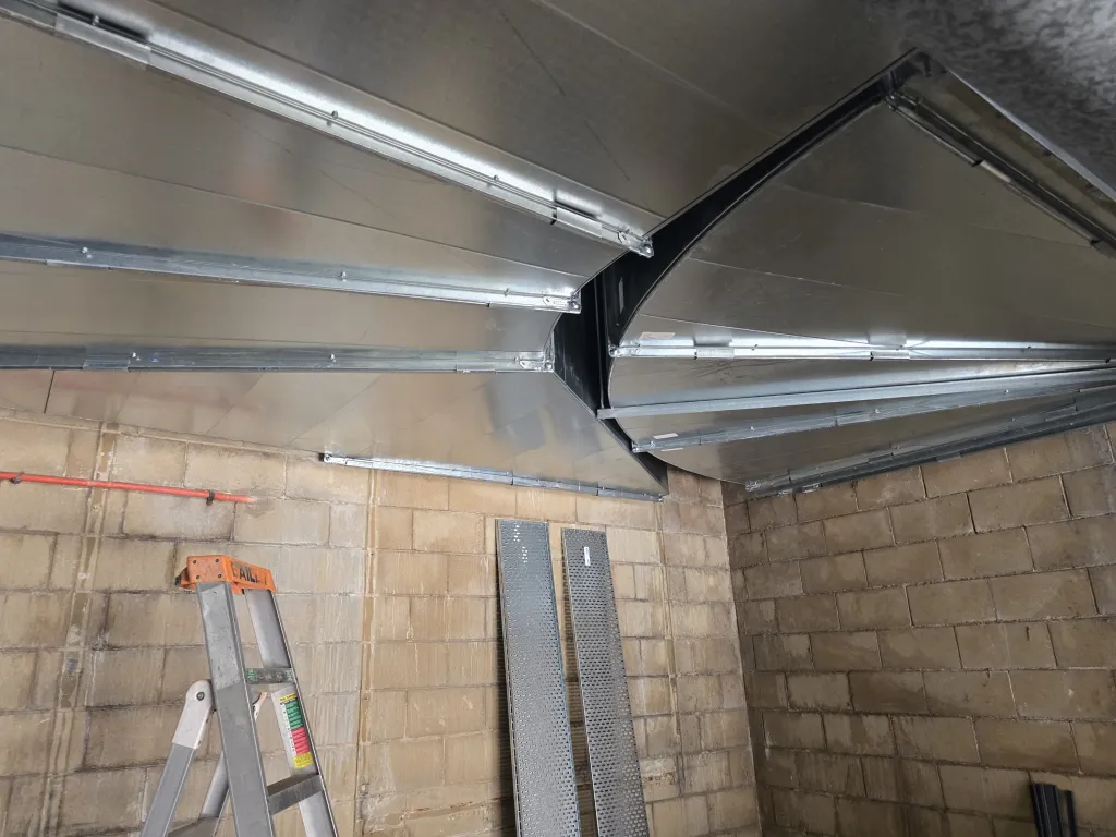 Galvanised duct support framing under the roof of the pool plant room