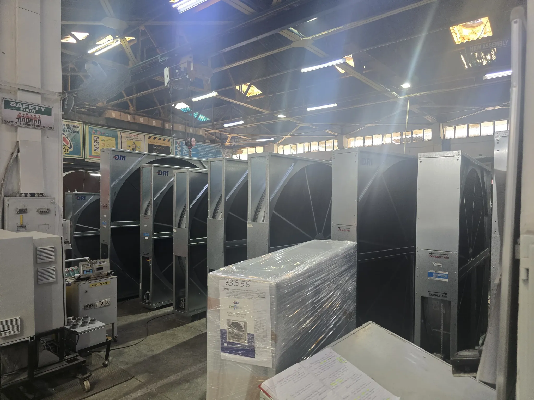 Air handling unit frames and a packaged dehumidifier in a factory workshop